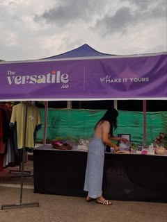 The Versatile Co pop-up stall with a purple 'make it yours' banner
